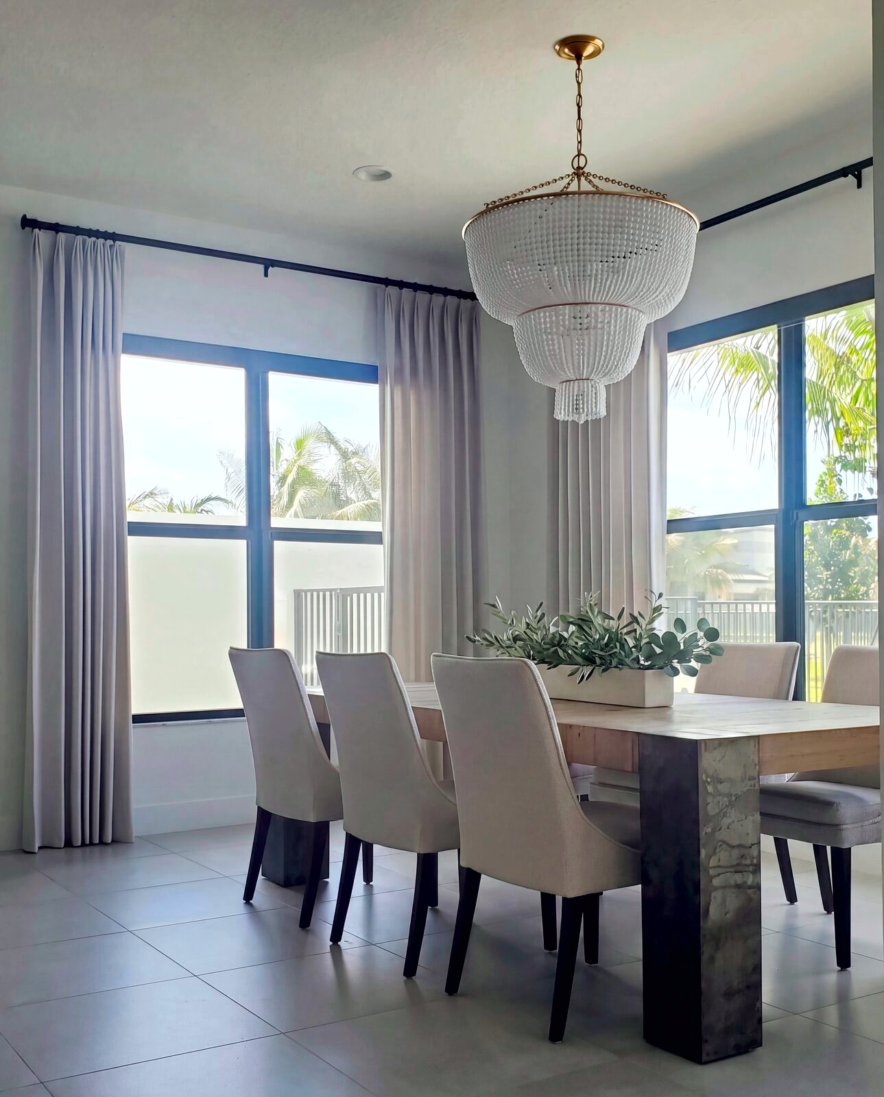 Dining room with beaded chandelier and palm views