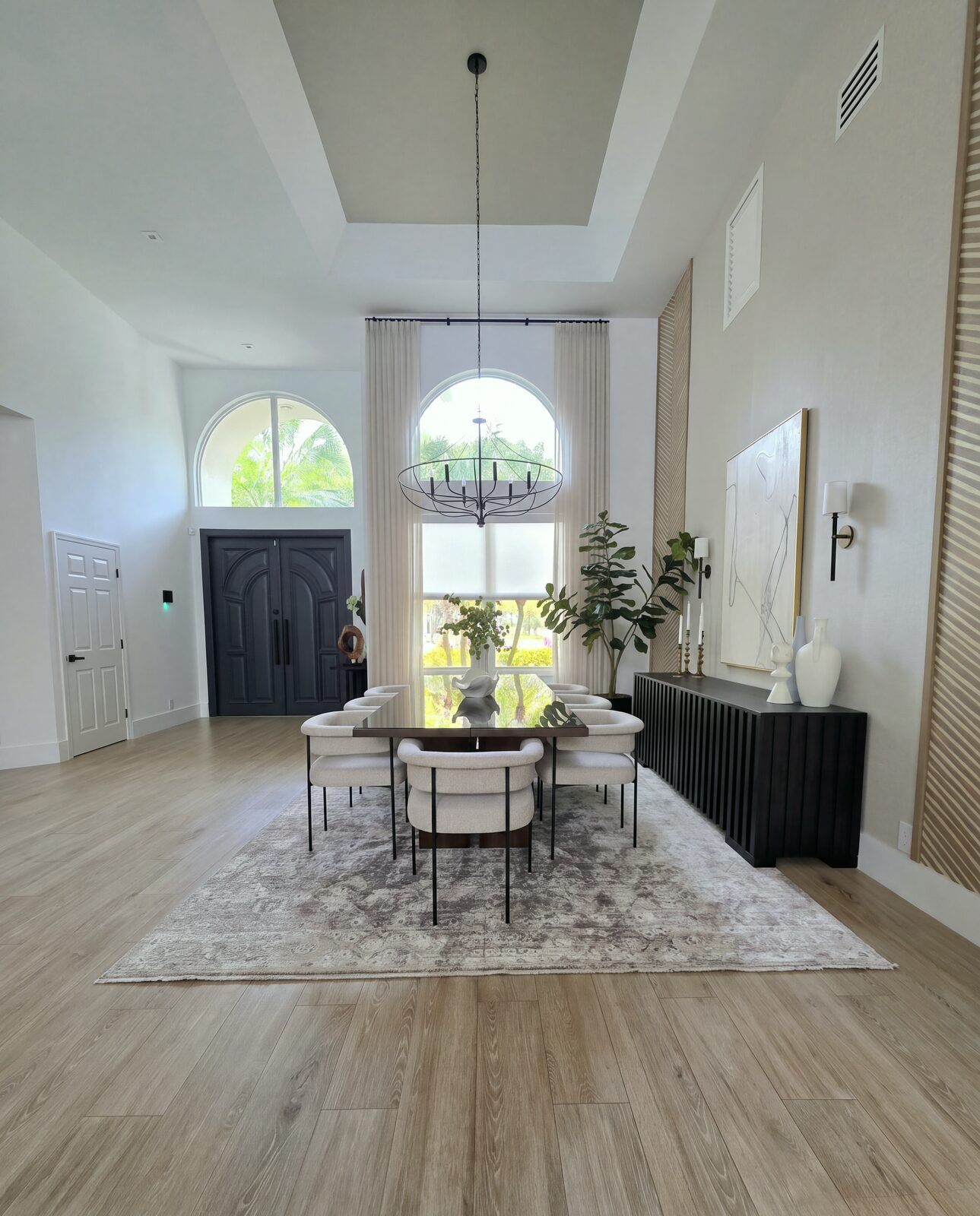 Entry with arched window and formal dining