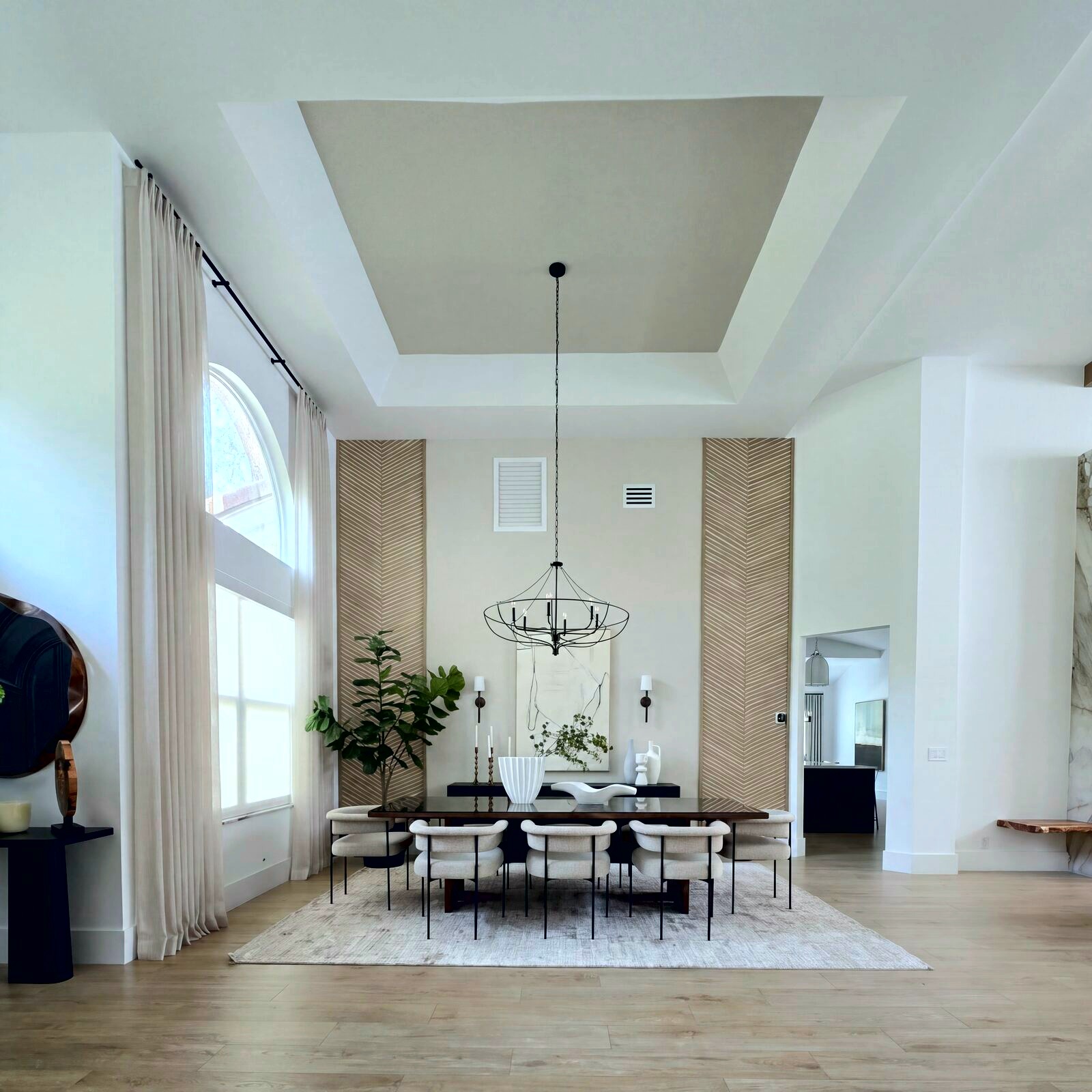 Formal dining room with tray ceiling and statement chandelier