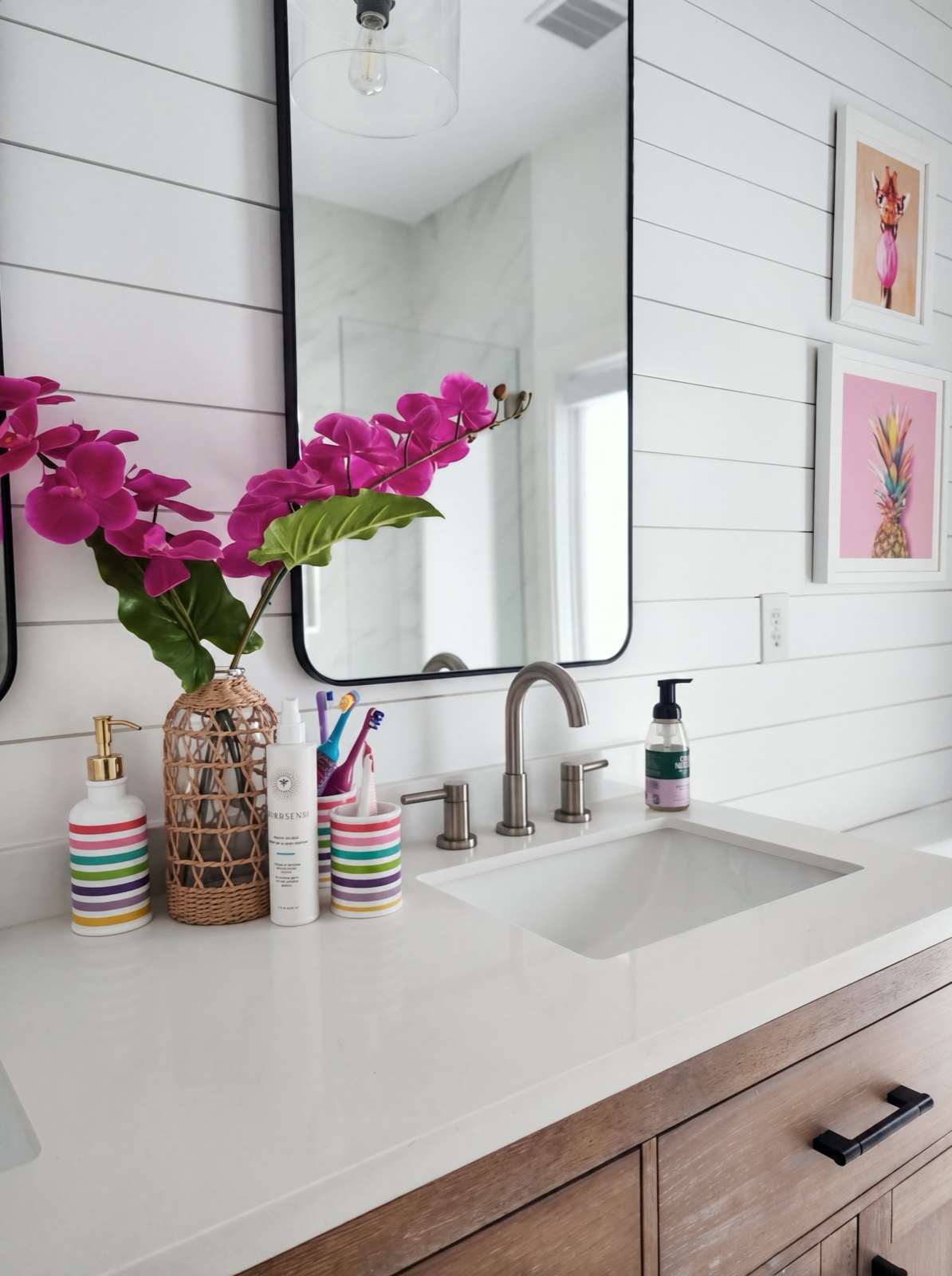 Bathroom vanity with shiplap walls, orchid, and playful striped accessories