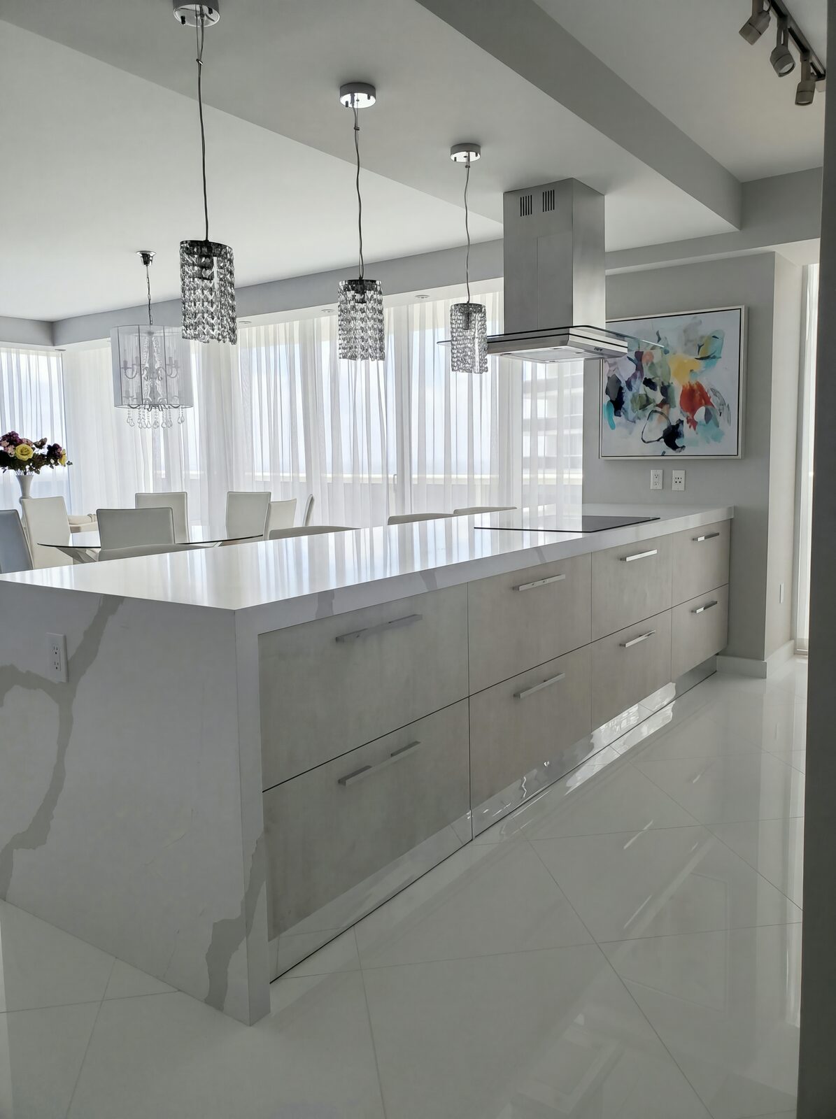 Kitchen island with waterfall quartz and crystal pendants