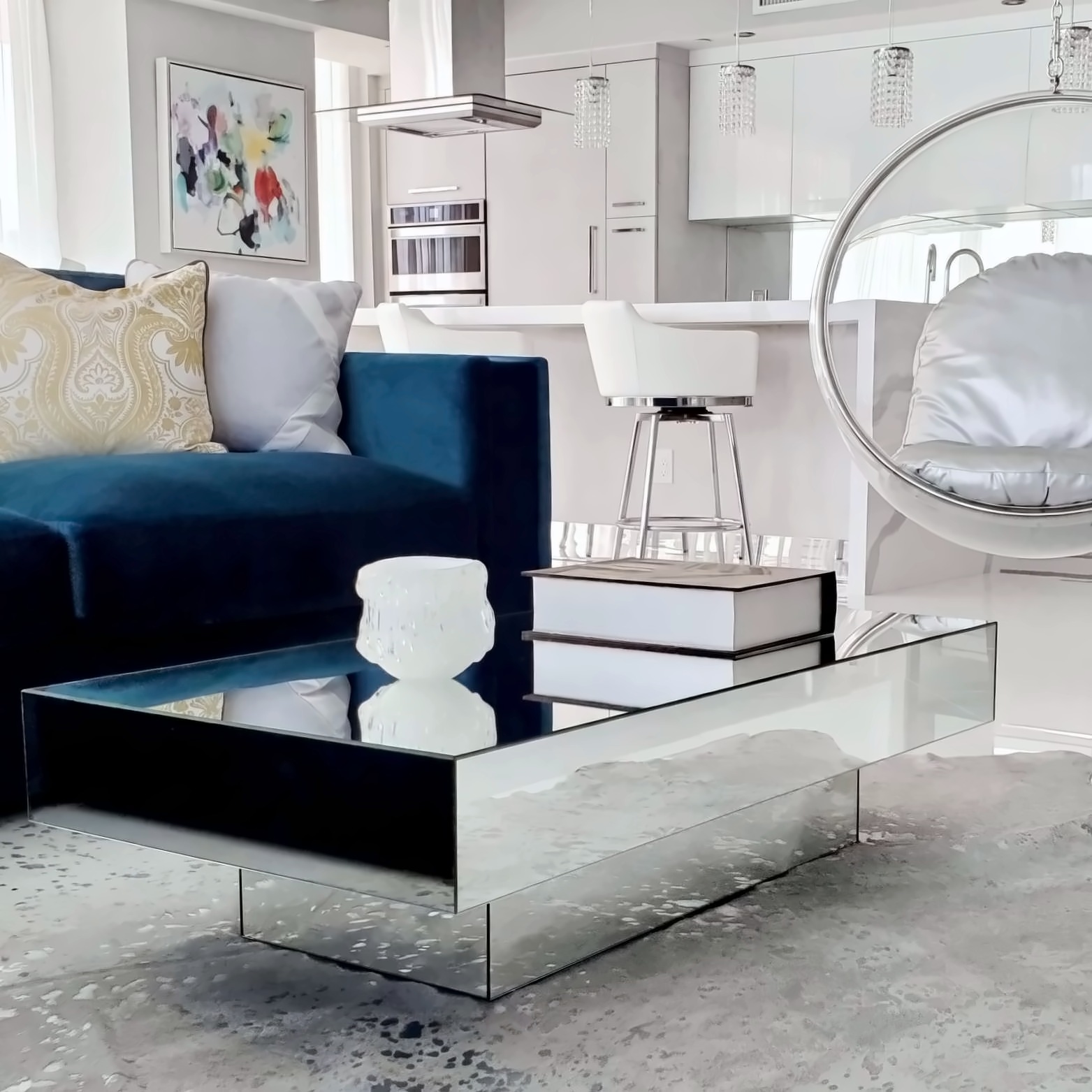 Teal velvet sectional with mirrored coffee table and hanging bubble chair